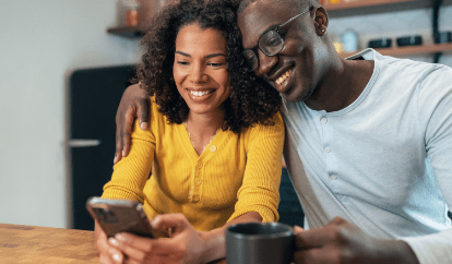 Couple at table looking at phone